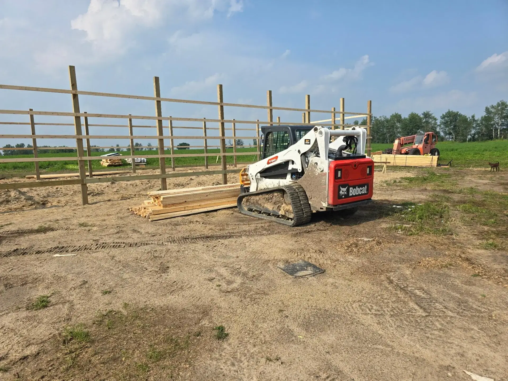 Skid steer on site during pole barn construction prep