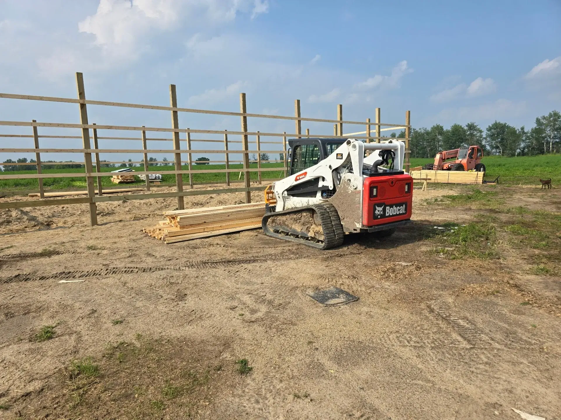 Skid steer on site during pole barn construction prep