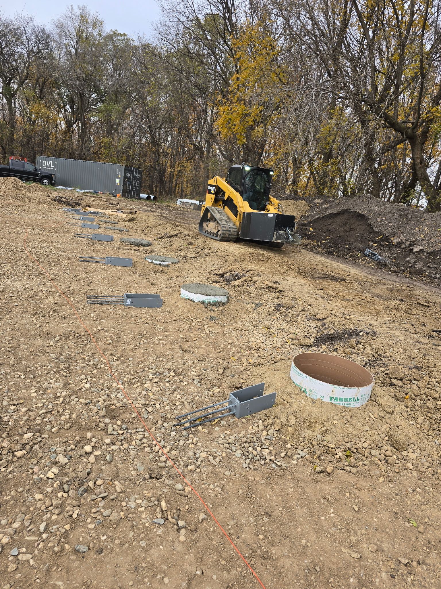 Crew setting pole barn foundation posts