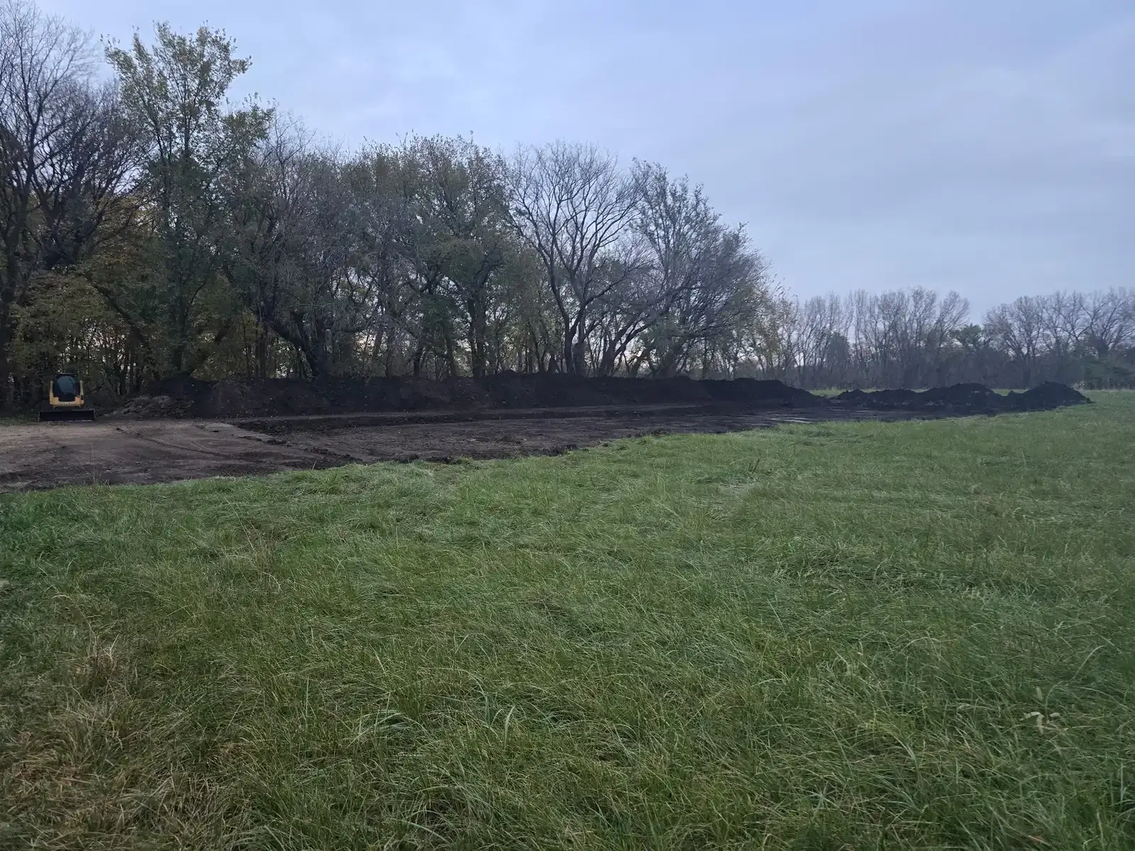 Open green field before pole barn construction begins