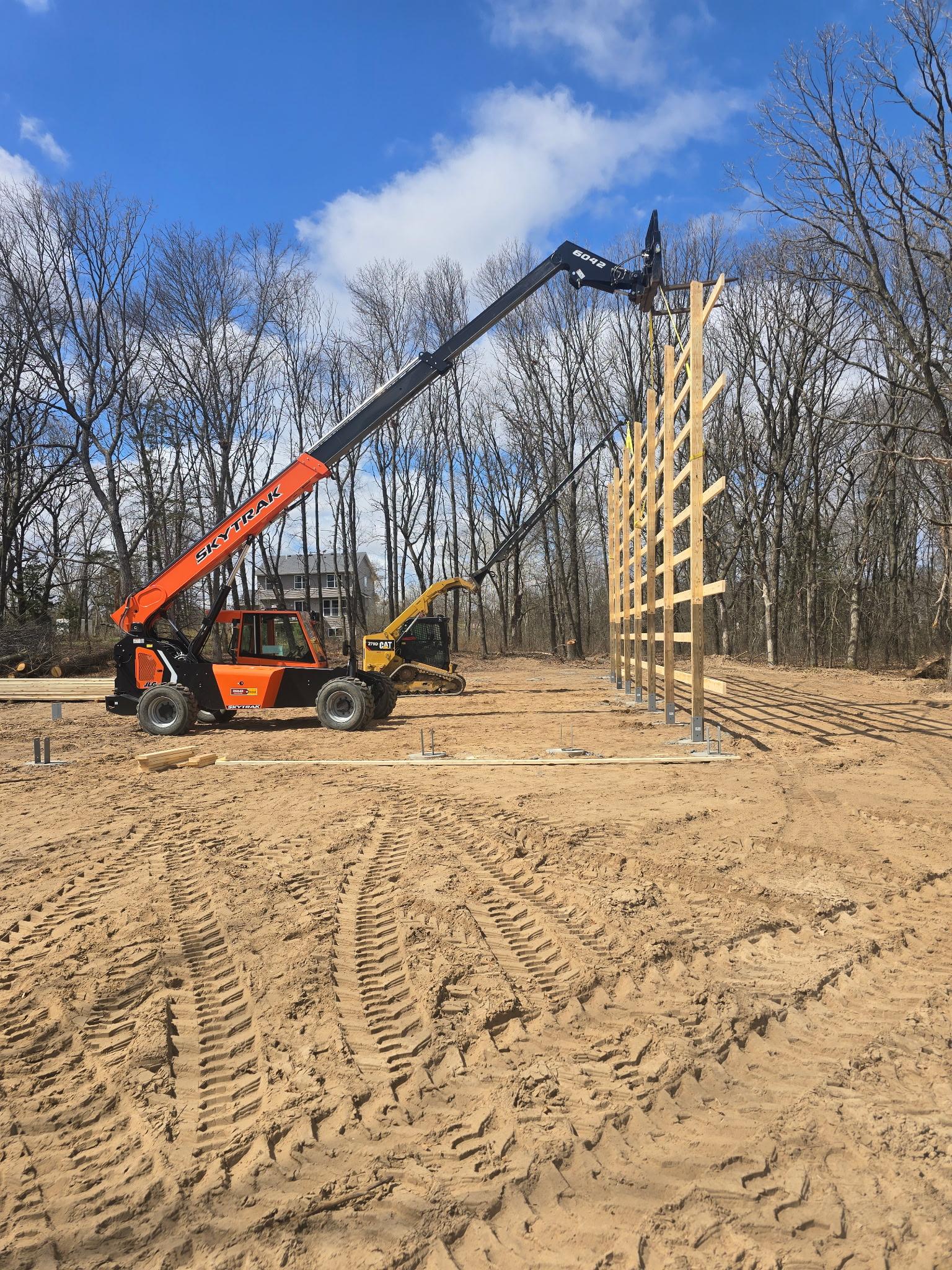 Crew lifting a framed wall during Orton pole barn construction