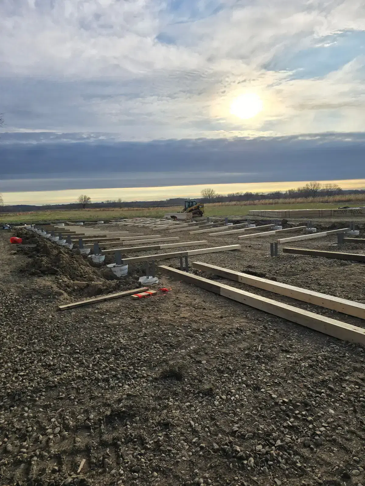 Pole barn construction materials staged on site