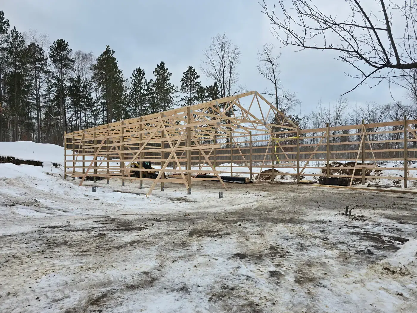 Pole barn frame erected in winter before roofing